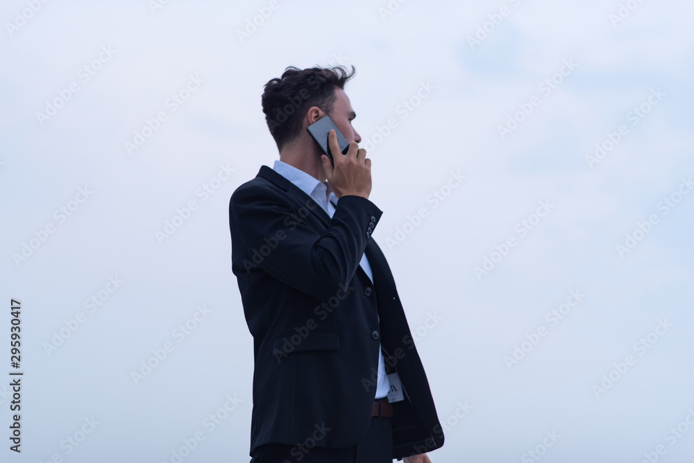 businessman using smartphone, with black suit businessman using smartphone, with black suit