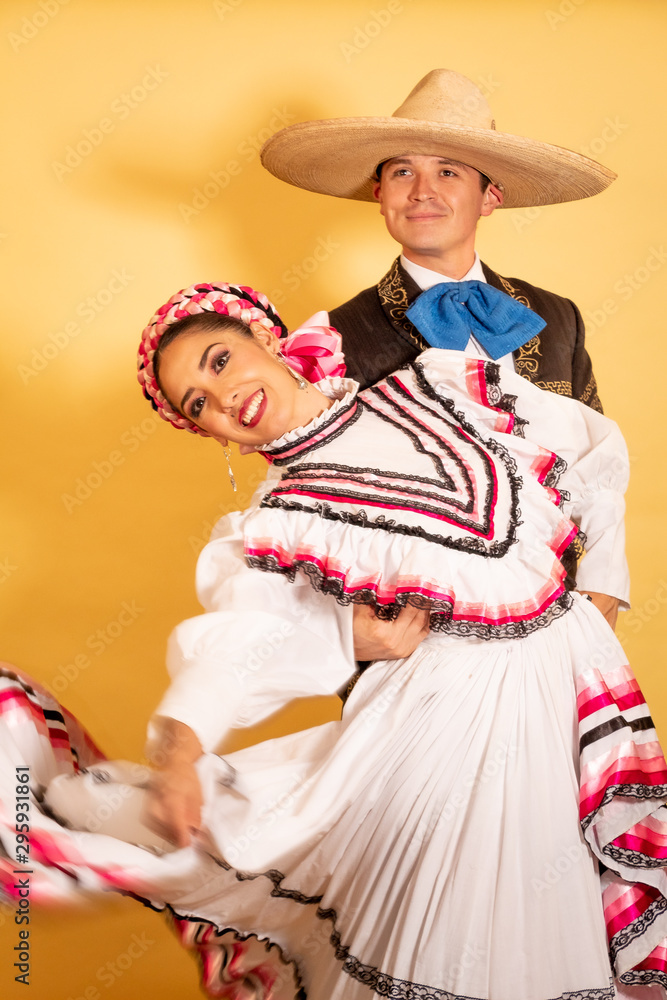 Charro and Adelita dancing young couple portrait in love folk culture 
