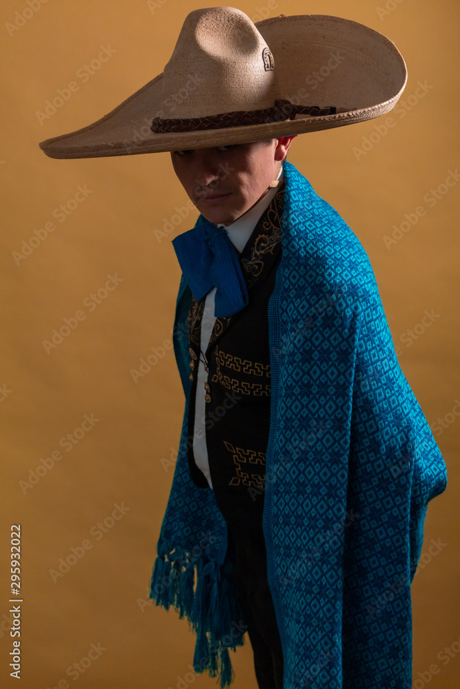 Charro young Mexican portrait with blue sarape posing with sombrero ...