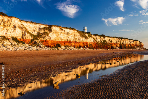 Bild auf Leinwand Light house reflection on the cliffs of Hunstanton Norfolk east Anglia England