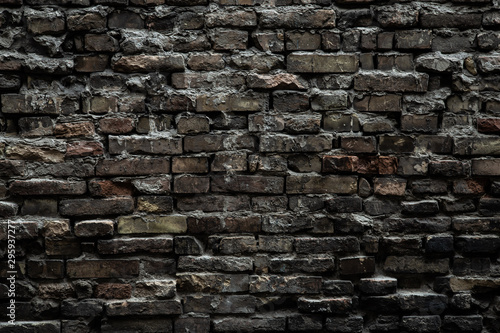 Urban black brick wall texture old masonry background. Gloomy background  black brick wall of dark stone texture