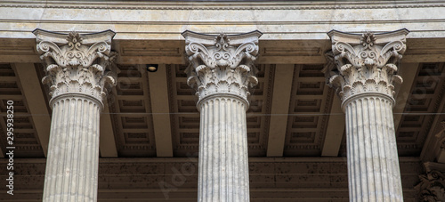 Vintage Old Justice Courthouse Column. Neoclassical colonnade with corinthian columns as part of a public building resembling a Greek or Roman temple