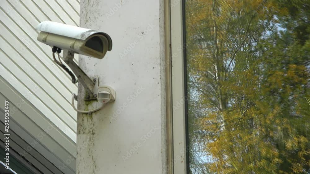 Security camera installed on white wall. Security camera installed on white wall.