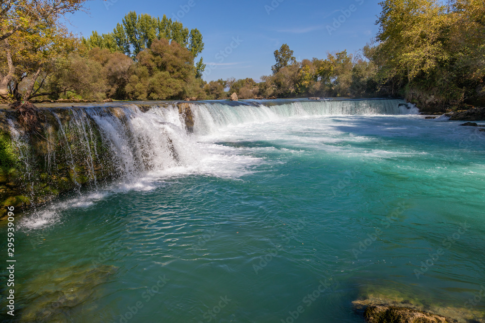 under a bright blue sky you can see the waterfall of Manavgat under a bright blue sky you can see the waterfall of Manavgat
