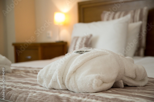 Folded bathrobe on bed in room