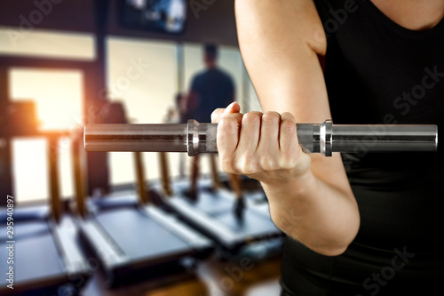 Dumbbell, barbell and workout in the gym. Copy space with blurred gym background.