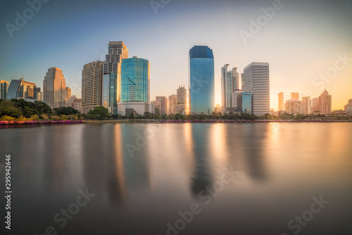 Lake in Public Park under Skyscrapers at Sunrise. Benjakiti Park in Bangkok, Thailand © kaycco