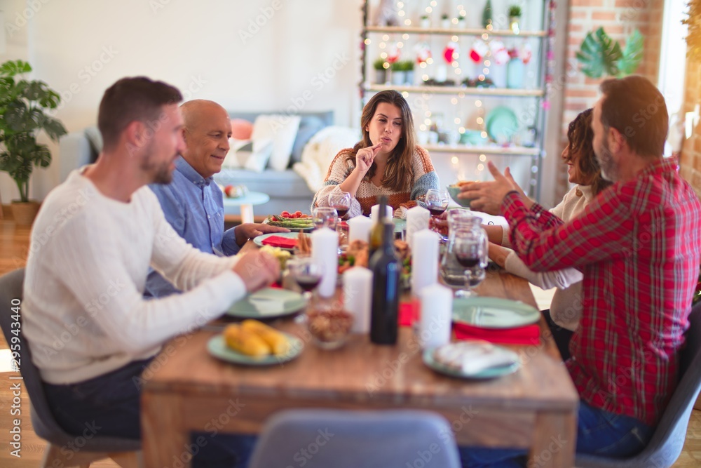 Beautiful family smiling happy and confident. Eating roasted turkey celebrating Christmas at home Beautiful family smiling happy and confident. Eating roasted turkey celebrating Christmas at home