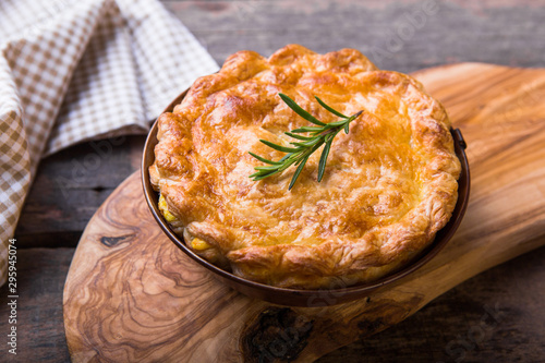 Individual chicken pot pie with puff pastry crust. top view photo