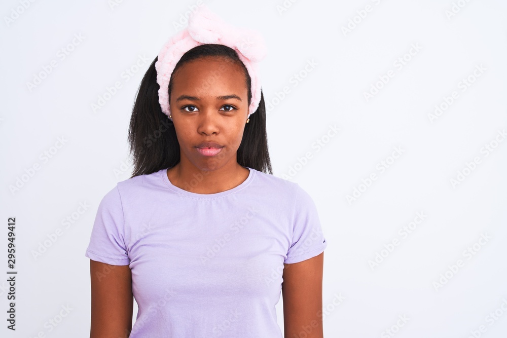 Beautiful young african american woman wearing a beauty diadem over isolated background with a confident expression on smart face thinking serious Beautiful young african american woman wearing a beauty diadem over isolated background with a confident expression on smart face thinking serious