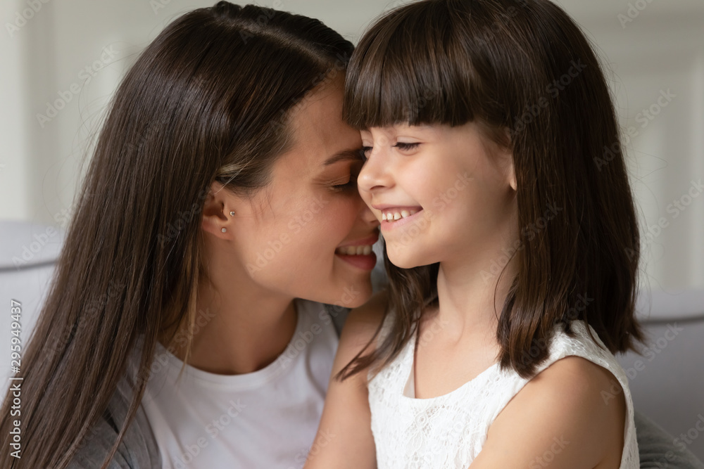 Head shot close up happy young mother bonding little daughter. Head shot close up happy young mother bonding little daughter.