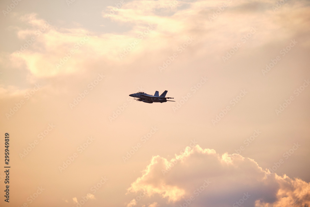Australian Air Force fighter jet flying through Brisbane at sunset