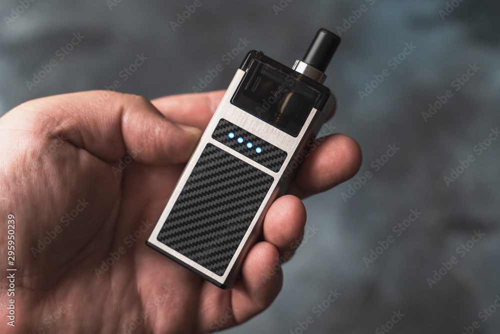 Φωτογραφία Vape pod in male hand or pod mod close up - newest generation of vaping products