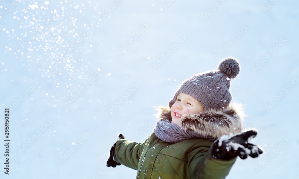 Little boy is having fun playing with snow. Active outdoors leisure with children in winter. Little boy is having fun playing with snow. Active outdoors leisure with children in winter.