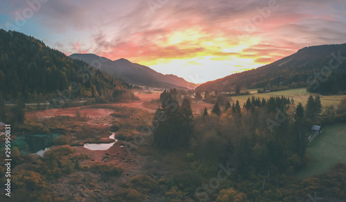 Early morning in the nature reservate of Zelenci, Slovenia, the spring of Sava Dolinka river. Beautiful dreamy morning setting, fairy tale vivid colors and still lake visible. photo