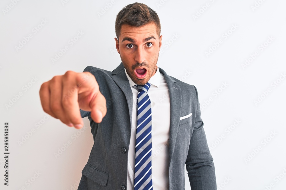 Young handsome business man wearing suit and tie over isolated background pointing displeased and frustrated to the camera, angry and furious with you Young handsome business man wearing suit and tie over isolated background pointing displeased and frustrated to the camera, angry and furious with you
