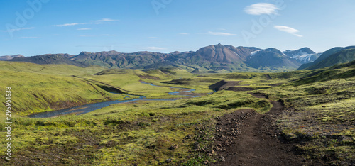 Panoramic landscape with blue river stream, green hills, snow-capped mountains, meadow and lush moss. Laugavegur hiking trail. with Fjallabak Nature Reserve, Iceland. Summer blue sky photo