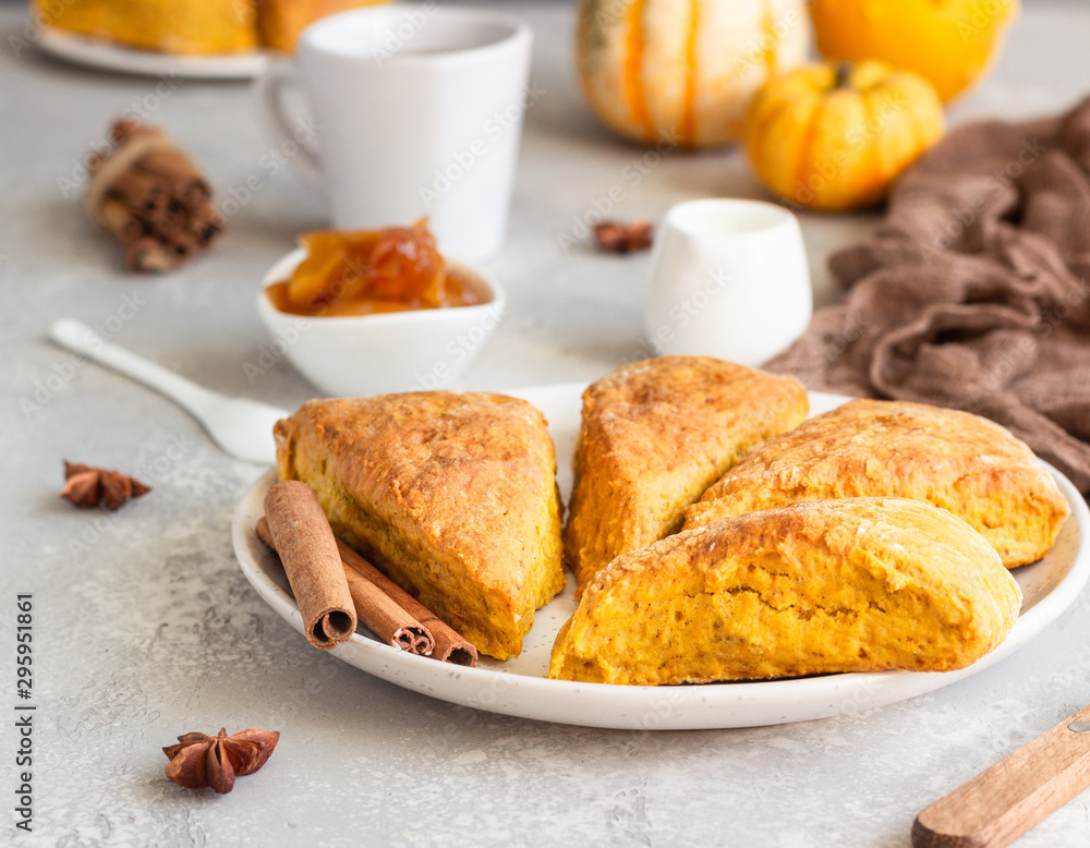 Traditional English cuisine. Breakfast with spicy pumpkin scones, a cup of tea and milk. Traditional English cuisine. Breakfast with spicy pumpkin scones, a cup of tea and milk.