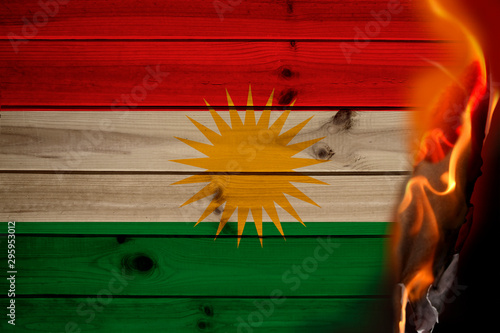 photo of burning national flag of kurdistan state, rojava closeup, concept of state crisis, destruction, illustration photo