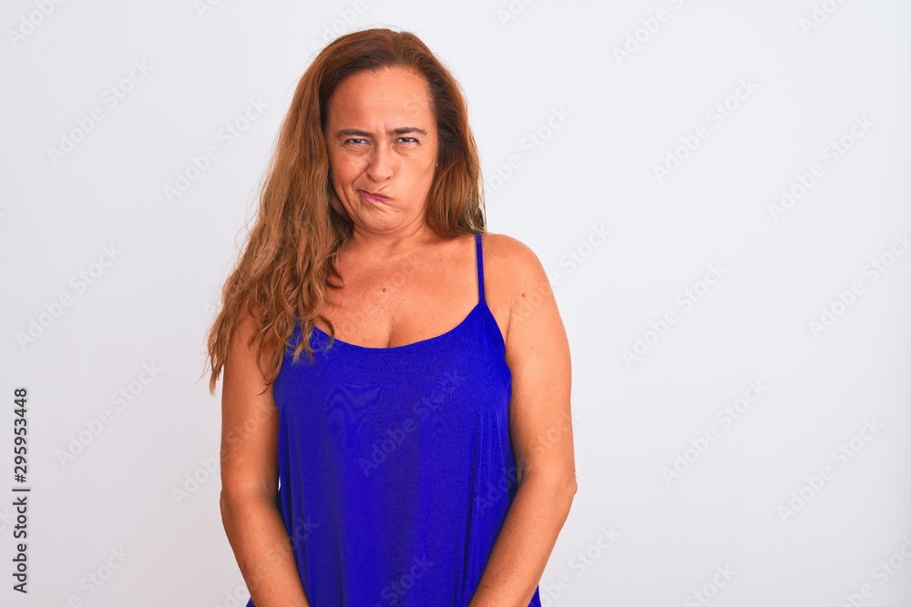 Middle age mature woman standing over white isolated background skeptic and nervous, frowning upset because of problem. Negative person. Middle age mature woman standing over white isolated background skeptic and nervous, frowning upset because of problem. Negative person.