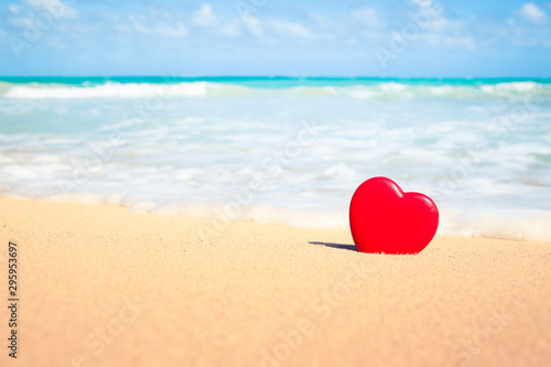 Heart in the sand on a beautiful Hawaii beach. Romantic beach getaway concept. 