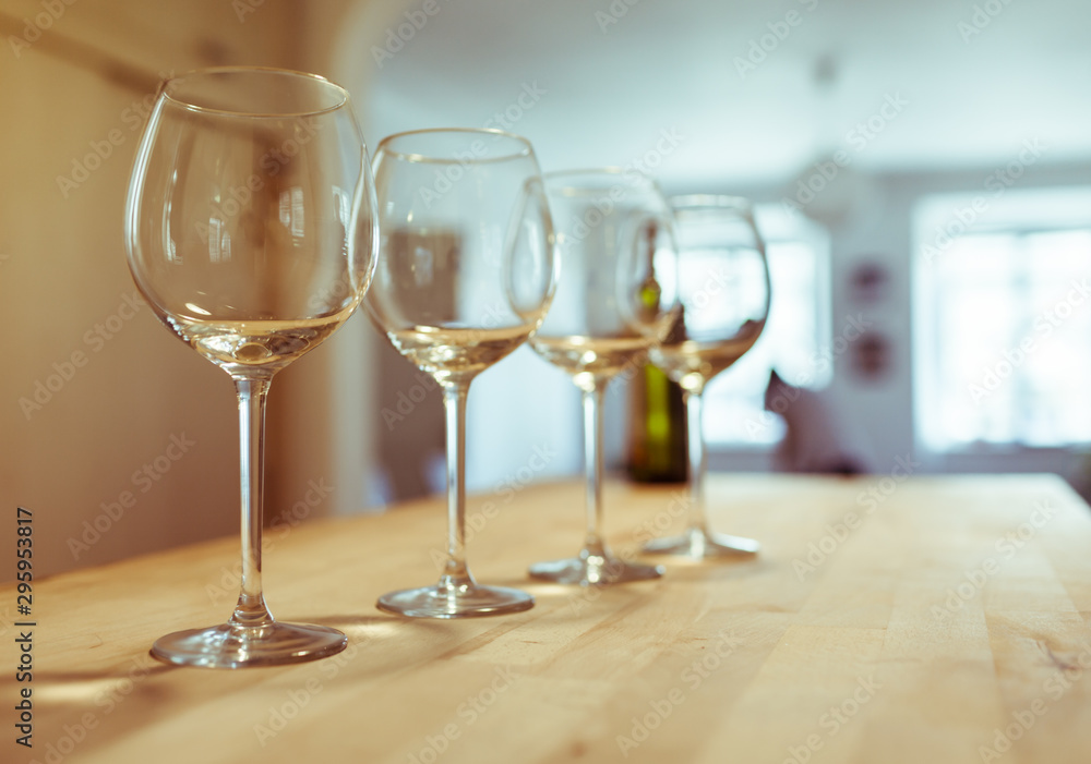 Clean empty row of wine glasses on bar table. Clean empty row of wine glasses on bar table.