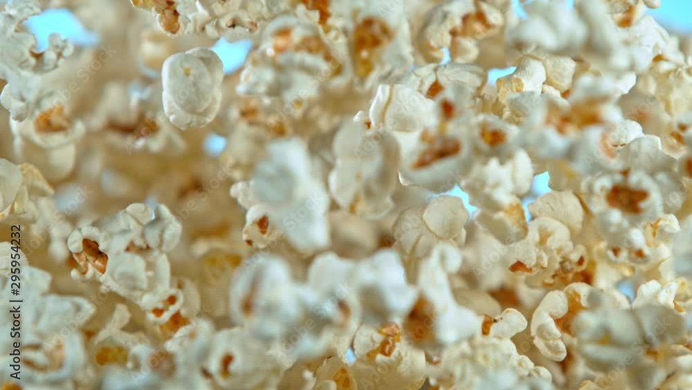 Super Slow Motion Shot of Popcorn on Blue Background after being Exploded at 1000fps. Super Slow Motion Shot of Popcorn on Blue Background after being Exploded at 1000fps.