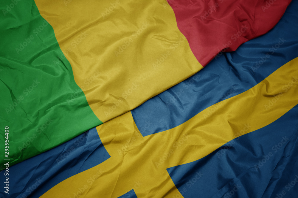 waving colorful flag of sweden and national flag of mali.