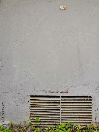 Texture, background, wallpaper, burgundy iron or metal grate image in a gray concrete wall