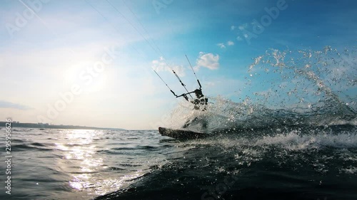 One man rides a kiteboard while training on water.