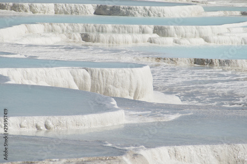 Pamukkale in Turkey is known for its mineral-rich thermal waters flowing down white travertine terraces. Pamukkale is nicknamed the cotton castle because of its white appearance. © Afonso Farias