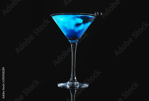 Glass of tasty cocktail on dark background