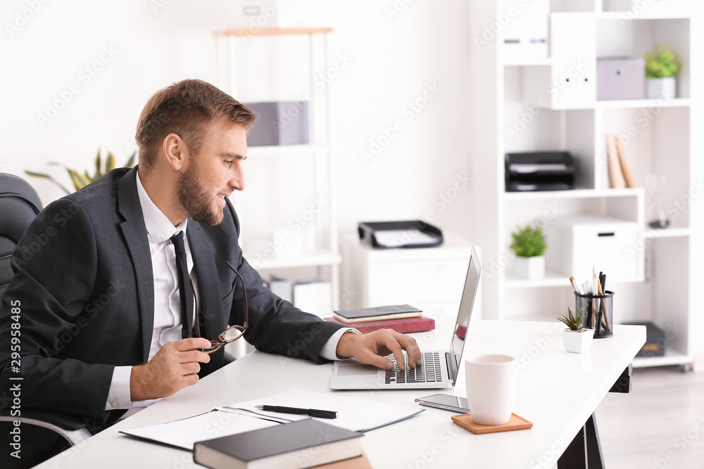 Portrait of handsome businessman working in office Portrait of handsome businessman working in office