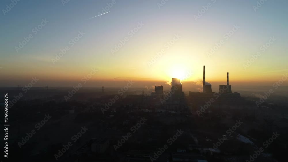Aerial drone view of big powerhouse. Big industry chimneys in power plant. Big city and big chimneys on sunset background. Concept: energy, pollution, climate change, activists. Aerial drone view of big powerhouse. Big industry chimneys in power plant. Big city and big chimneys on sunset background. Concept: energy, pollution, climate change, activists.