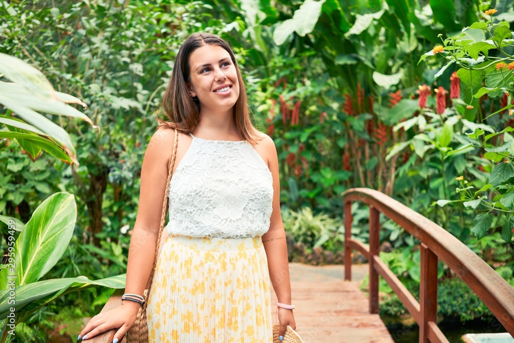 Young beatiful woman smiling happy and cheerful at butterfly garden on a sunny day of summer Young beatiful woman smiling happy and cheerful at butterfly garden on a sunny day of summer