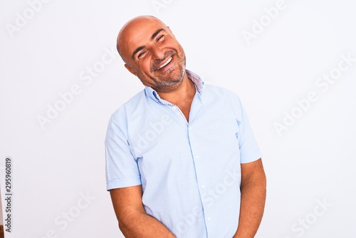 Middle age handsome man wearing casual shirt standing over isolated white background looking away to side with smile on face, natural expression. Laughing confident.