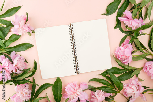 Fototapeta Naklejka Na Ścianę i Meble -  open spiral notebook with blank white pages on a beige background