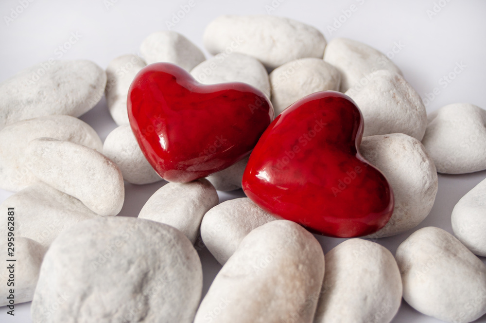 Obraz premium Abstract Background of white stones with two red hearts