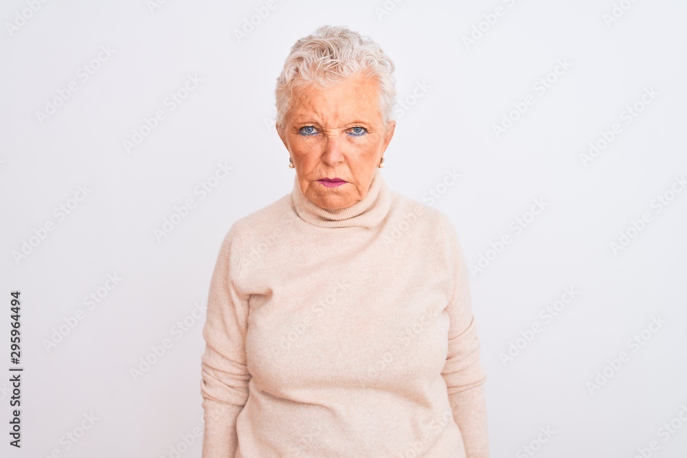 Senior grey-haired woman wearing turtleneck sweater standing over isolated white background skeptic and nervous, frowning upset because of problem. Negative person. Senior grey-haired woman wearing turtleneck sweater standing over isolated white background skeptic and nervous, frowning upset because of problem. Negative person.