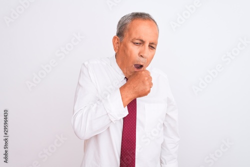 Senior grey-haired businessman wearing elegant tie over isolated white background feeling unwell and coughing as symptom for cold or bronchitis. Healthcare concept.