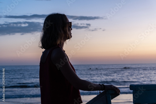 Beautiful Woman Silhouette Watching The Ocean from a Lifeguard Tower in California