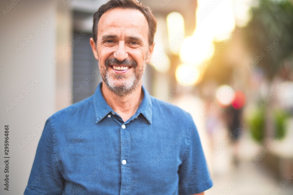 Middle age handsome man standing on the street smiling Middle age handsome man standing on the street smiling