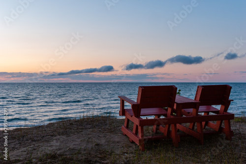 two chairs on the beach over looking Lake Superior in Michigan s Upper Peninsula