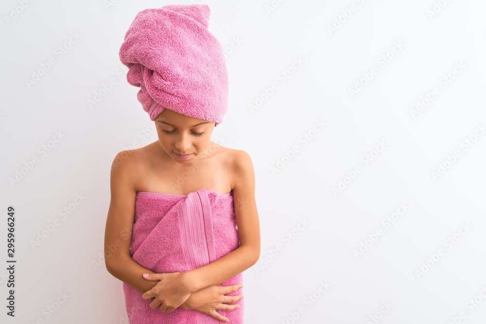 Beautiful child girl wearing shower towel after bath standing over isolated white background with hand on stomach because indigestion, painful illness feeling unwell. Ache concept. Beautiful child girl wearing shower towel after bath standing over isolated white background with hand on stomach because indigestion, painful illness feeling unwell. Ache concept.