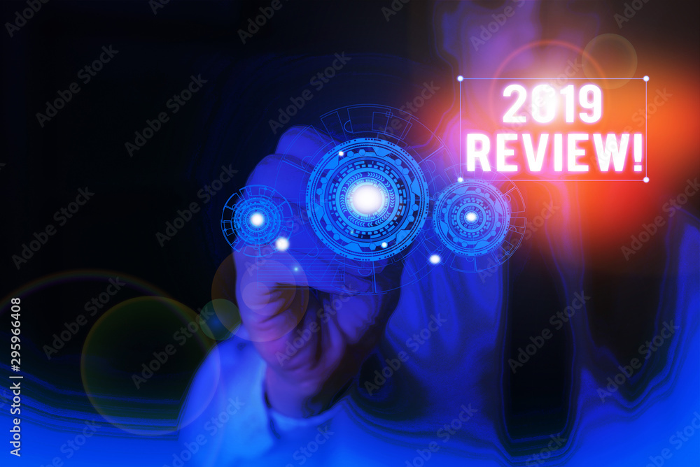 Text sign showing 2019 Review. Business photo showcasing remembering past year events main actions or good shows Woman wear formal work suit presenting presentation using smart device