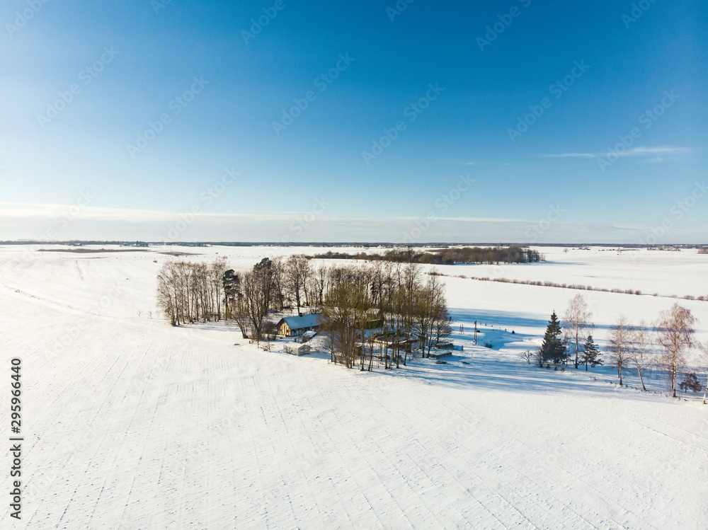 Beautiful aerial view of snow covered fields. Rime ice and hoar frost covering trees.