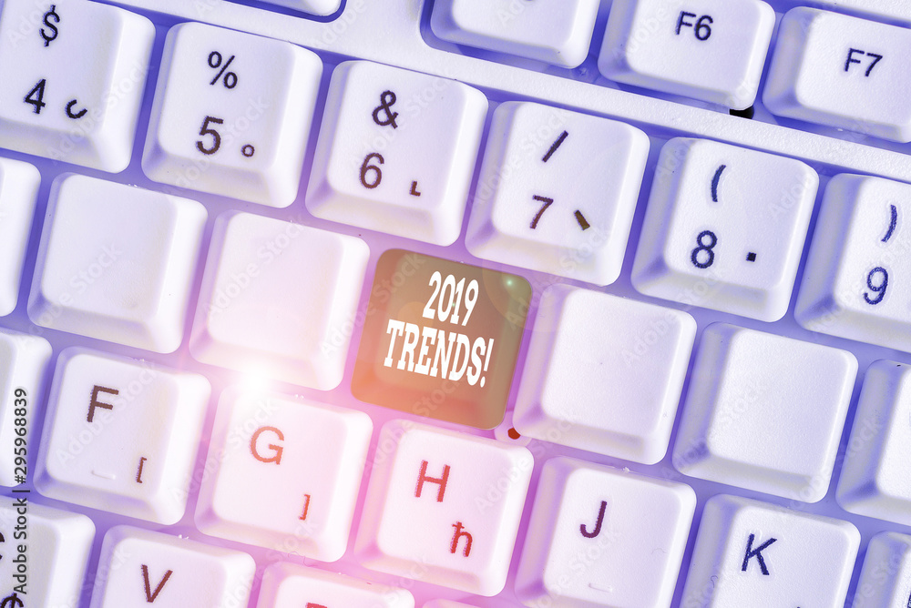 Handwriting text writing 2019 Trends. Conceptual photo general direction in which something is developing or changing White pc keyboard with empty note paper above white background key copy space Handwriting text writing 2019 Trends. Conceptual photo general direction in which something is developing or changing White pc keyboard with empty note paper above white background key copy space