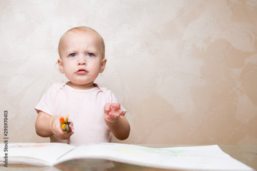 very upset child holds pencils and crayons in his hand very upset child holds pencils and crayons in his hand