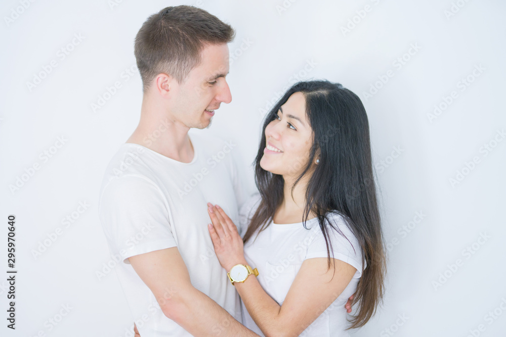 Young beautiful couple standing together over isolated white background Young beautiful couple standing together over isolated white background