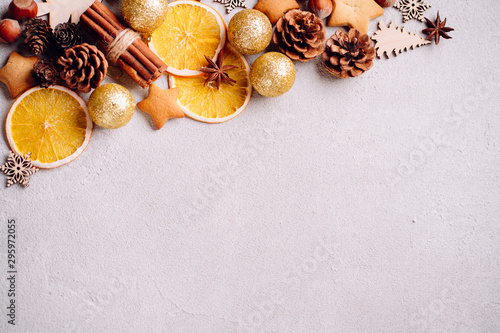 Christmas vibes, celebration atmosphere. Winter composition, background made of dried orange slices, pine cones and gingerbread cookies, New Year greeting card. Copy space
